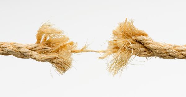 A frayed rope breaking in the middle against a white background