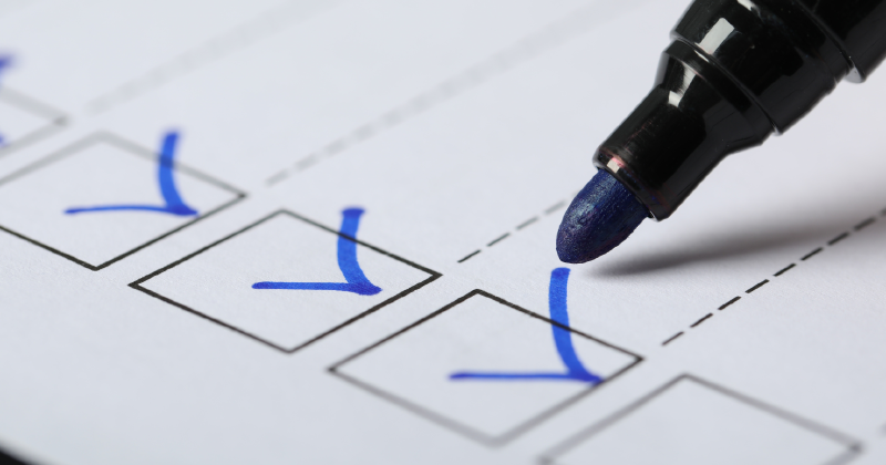 Marker ticking boxes on a compliance checklist